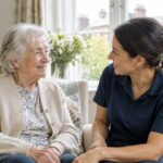 Senior woman talking with a caregiver in a bright living room